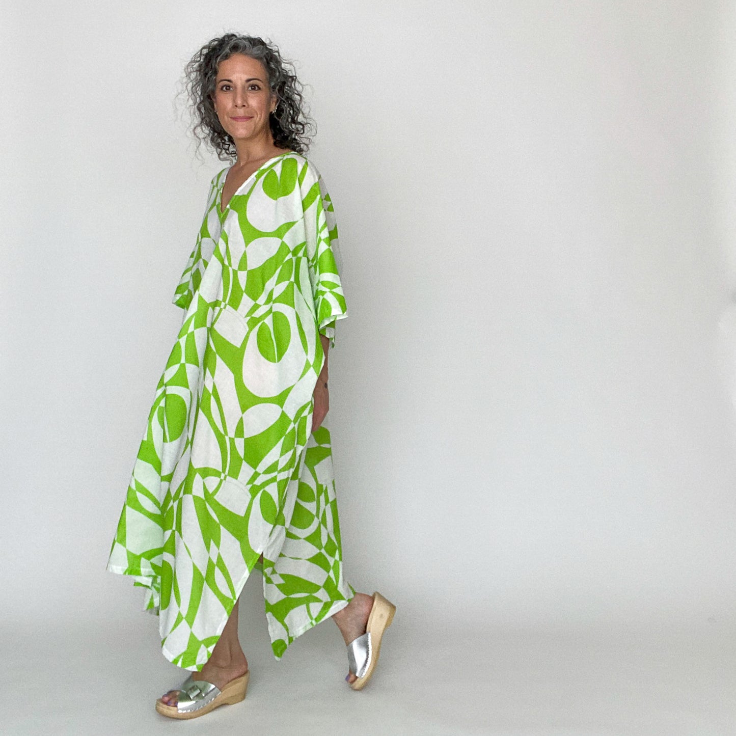 House of Lu Mae Caftan in Color Number 42 is a geometric print in a bright lime green and white. The fabric is a lightweight cotton lawn with a crisp drape. This caftan is absolutely perfect for the beach or for those hot summer days. Like a personal AC unit, Mae is guaranteed to keep you cool when the temps go up. 