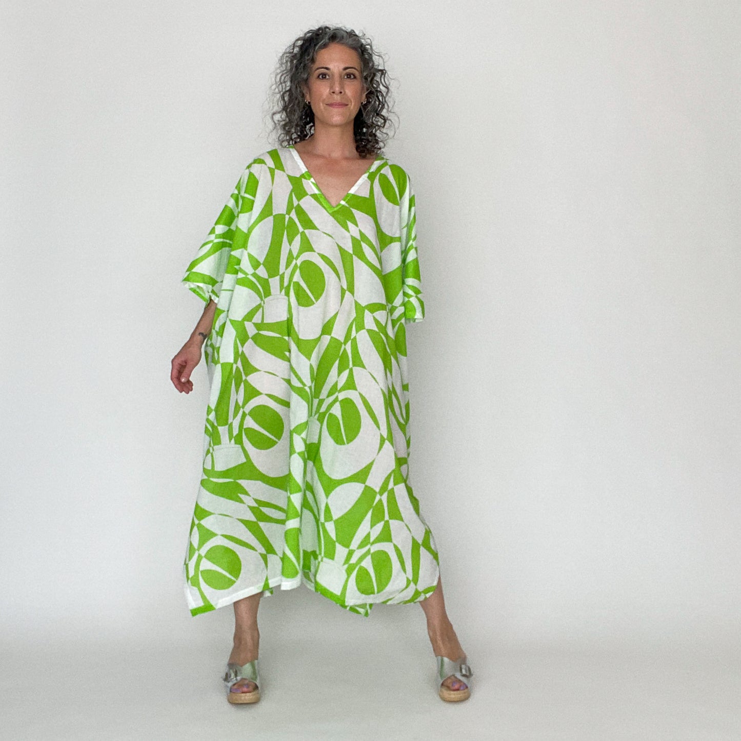 House of Lu Mae Caftan in Color Number 42 is a geometric print in a bright lime green and white. The fabric is a lightweight cotton lawn with a crisp drape. This caftan is absolutely perfect for the beach or for those hot summer days. Like a personal AC unit, Mae is guaranteed to keep you cool when the temps go up. 
