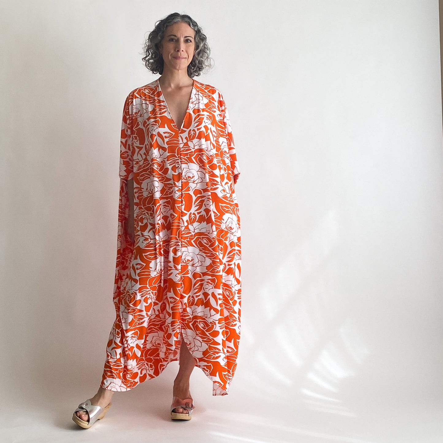 House of Lu Diana Caftan in Color Number 47. Orange and White vintage floral print in a vintage acetate fabric. Featured here in size Original. 