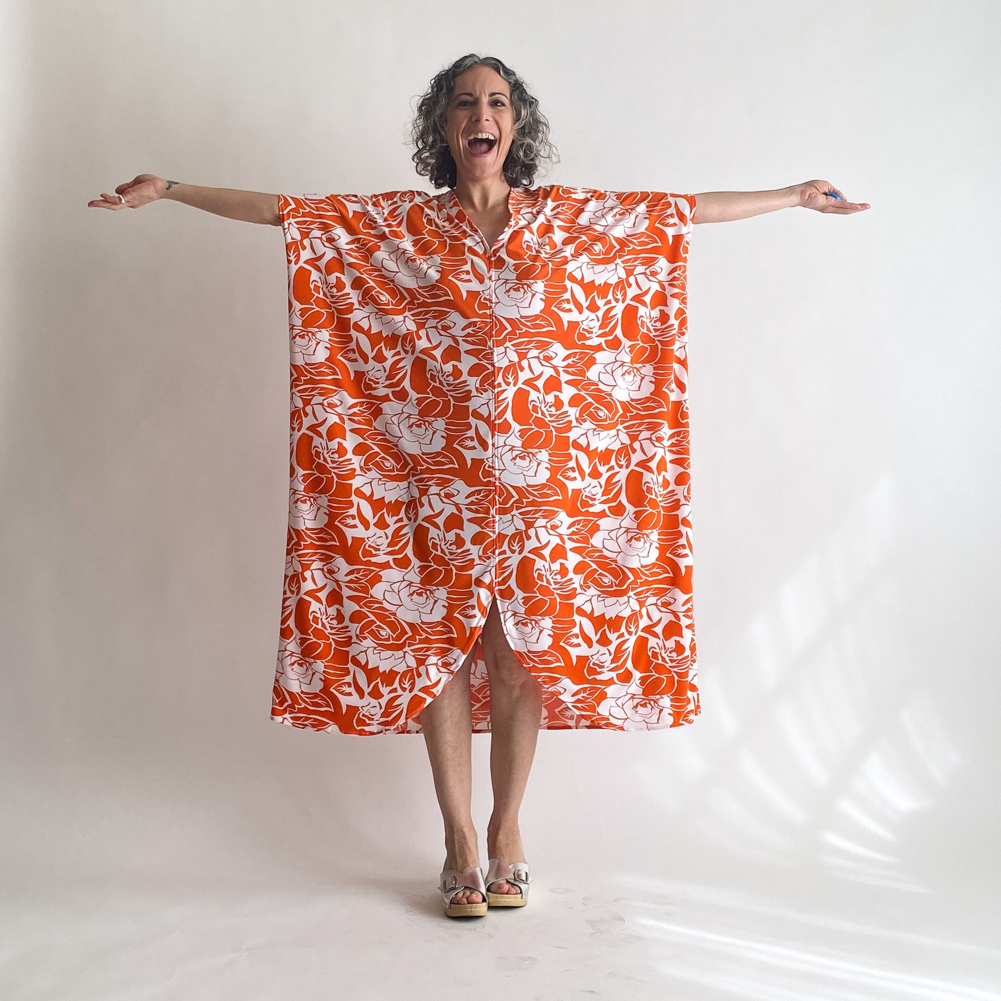 House of Lu Diana Caftan in Color Number 47. Orange and White vintage floral print in a vintage acetate fabric. Featured here in size Petite.